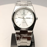 Silver watch on a stand with a white face