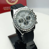 Black wristwatch with silver dial on a stand, brand box in the background