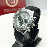 Black watch with silver bezel on a stand, brand box in the background