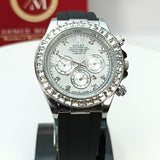 Luxury watch with black strap and silver dial on a stand, with a red box in the background.