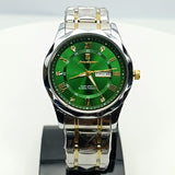 Green watch with silver and gold accents on a white background