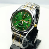 Wristwatch with green dial and silver and gold band on a white background