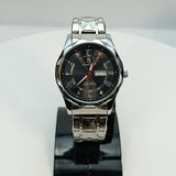 Silver wristwatch with a black face on a white background