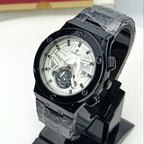 Luxury watch on a stand with a branded box in the background