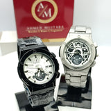 Two watches on stands with a branded box in the background