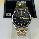 Gold and silver watch with black face on a clear stand