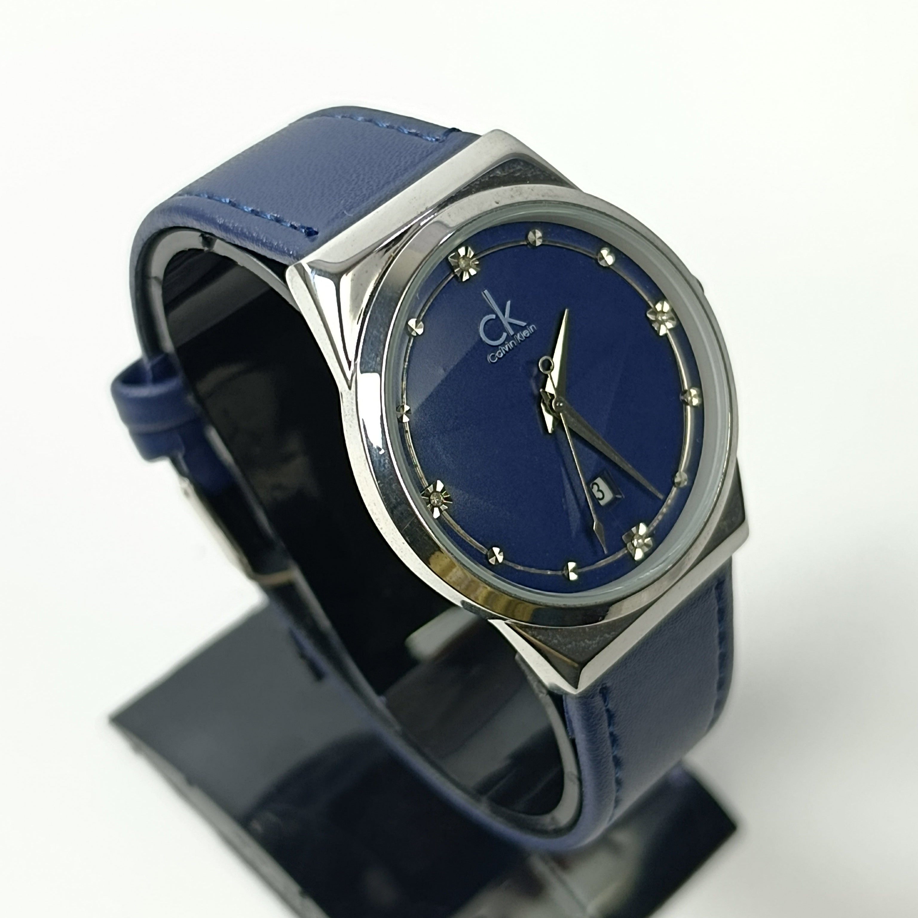 Blue watch with silver case on a white background