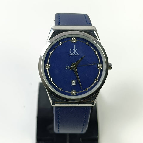 Blue Calvin Klein watch on a white background