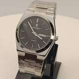 Silver watch on a black stand against a light gray background
