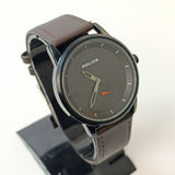 Watch with brown leather strap and dark gray dial on a white background