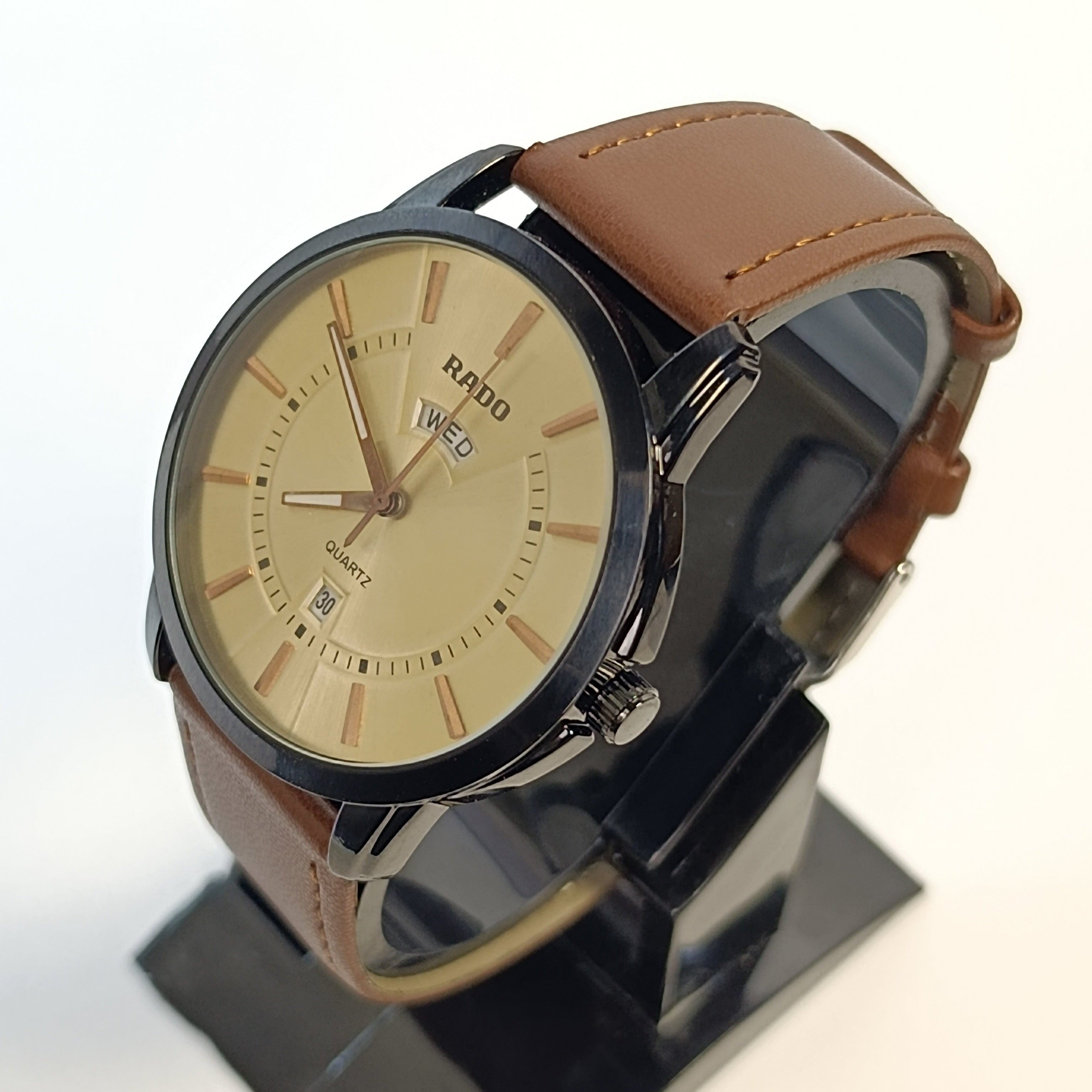 Rado watch with brown leather strap on a stand against a white background
