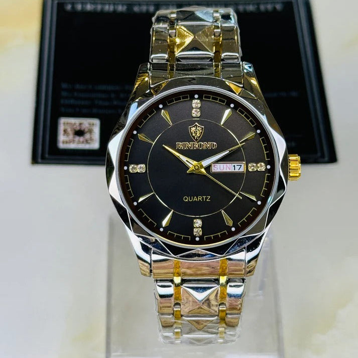 Gold and silver watch with black face on a clear stand